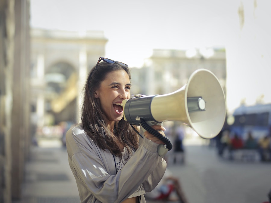 girl with megaphone important qualities of a successful writer